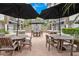 Outdoor patio with multiple tables and chairs under umbrellas at 630 Vassar St # 2508, Orlando, FL 32804