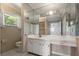 This bathroom features a white vanity and sink with a large mirror, and decorative wallpaper at 6416 Jackwood Ct, Orlando, FL 32818