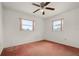 Empty bedroom with two windows, carpet, and a ceiling fan at 6416 Jackwood Ct, Orlando, FL 32818