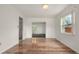 Bright dining room with light hardwood floors, white walls, and a large window at 6416 Jackwood Ct, Orlando, FL 32818