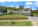 Two-story home with neutral paint, landscaped front yard, and attached one-car garage at 6416 Jackwood Ct, Orlando, FL 32818