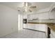A cozy kitchen with white cabinetry, tile flooring, and countertops at 6416 Jackwood Ct, Orlando, FL 32818