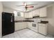 Traditional kitchen features ample white cabinetry, appliances, and tile flooring at 6416 Jackwood Ct, Orlando, FL 32818