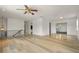 Spacious living room with light hardwood floors, white walls, and a ceiling fan at 6416 Jackwood Ct, Orlando, FL 32818