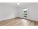 Bedroom with a large window allowing for natural light and smooth neutral flooring at 7440 Houston E Ct, Winter Park, FL 32792