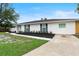 Charming single-story home featuring a freshly painted exterior, manicured lawn, and updated landscaping at 7440 Houston E Ct, Winter Park, FL 32792