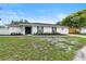 Beautiful single-story home with a well-maintained lawn, freshly painted exterior, and a cozy walkway at 7440 Houston E Ct, Winter Park, FL 32792