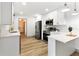 Modern kitchen with white cabinets, stainless steel appliances, and quartz countertops at 7440 Houston E Ct, Winter Park, FL 32792