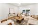 Cozy living room featuring stylish furniture, natural lighting, and a seamless layout to the dining area at 7440 Houston E Ct, Winter Park, FL 32792