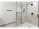Sleek bathroom shower featuring frameless glass, modern fixtures, and elegant marble-style tiling at 7440 Houston E Ct, Winter Park, FL 32792