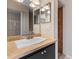 Bathroom featuring a vanity with black cabinets and neutral countertop, next to a shower at 7449 Daniel Webster Dr # 3, Winter Park, FL 32792