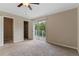 Bedroom with carpeted floor and sliding glass door to balcony at 7449 Daniel Webster Dr # 3, Winter Park, FL 32792