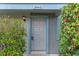 Close-up of the front door, featuring a grey painted door, exterior light, and digital lock at 7449 Daniel Webster Dr # 3, Winter Park, FL 32792