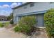 Two-story home featuring a grey painted facade, landscaping, and a covered entryway at 7449 Daniel Webster Dr # 3, Winter Park, FL 32792