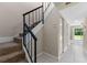 Hallway with tiled floor, staircase, and access to an outdoor patio at 7449 Daniel Webster Dr # 3, Winter Park, FL 32792