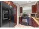 Well-equipped kitchen with black appliances, dark wood cabinets, and granite countertops at 7449 Daniel Webster Dr # 3, Winter Park, FL 32792