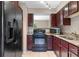 Well-lit kitchen featuring granite countertops, stainless steel microwave, and tile flooring at 7449 Daniel Webster Dr # 3, Winter Park, FL 32792