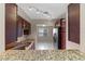 Kitchen with granite countertops and tile floor looking into adjacent room at 7449 Daniel Webster Dr # 3, Winter Park, FL 32792