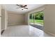 Spacious living room featuring tile flooring, neutral walls, and natural light from the sliding door at 7449 Daniel Webster Dr # 3, Winter Park, FL 32792