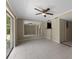 Bright and airy living room with tile flooring, a sliding door to the patio and kitchen access at 7449 Daniel Webster Dr # 3, Winter Park, FL 32792