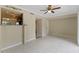 Open living area with tile floors, ceiling fan, and kitchen access with granite countertops at 7449 Daniel Webster Dr # 3, Winter Park, FL 32792