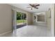 Open living room with neutral walls, ceiling fan, and sliding glass doors to the patio at 7449 Daniel Webster Dr # 3, Winter Park, FL 32792