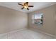 Neutral colored room with white tile, ceiling fan, and a window at 7449 Daniel Webster Dr # 3, Winter Park, FL 32792