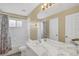 Bathroom featuring double sinks, a shower-tub combo, a vanity mirror, and neutral colors at 8113 Sun Palm Dr, Kissimmee, FL 34747