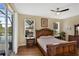Bedroom featuring a wood bed frame, wood floors, and access to the outdoor pool area at 8113 Sun Palm Dr, Kissimmee, FL 34747