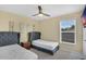Cozy bedroom featuring two twin beds with upholstered headboards and a ceiling fan at 8113 Sun Palm Dr, Kissimmee, FL 34747