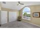 Bedroom featuring natural light, a double door closet, carpet, and a high vaulted ceiling at 8113 Sun Palm Dr, Kissimmee, FL 34747