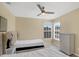 Bright bedroom featuring two twin beds, a ceiling fan, and a white dresser at 8113 Sun Palm Dr, Kissimmee, FL 34747