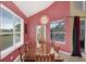 The dining room has a stylish chandelier, a large window with view, and an access door to the screened pool area at 8113 Sun Palm Dr, Kissimmee, FL 34747