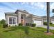 Two-story home with a bright red front door and a two-car garage at 8113 Sun Palm Dr, Kissimmee, FL 34747