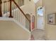 Inviting foyer with tiled floors, staircase, and a high ceiling with a hanging light fixture at 8113 Sun Palm Dr, Kissimmee, FL 34747