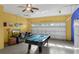 Garage transformed into a game room featuring a pool table and a TV at 8113 Sun Palm Dr, Kissimmee, FL 34747