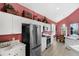 Bright kitchen with white cabinets, stainless steel appliances, and dining area at 8113 Sun Palm Dr, Kissimmee, FL 34747