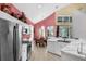 Open kitchen with stainless steel appliances, white cabinets and an adjacent dining area at 8113 Sun Palm Dr, Kissimmee, FL 34747