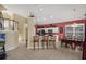 Bright, open kitchen with white cabinets, stainless steel appliances, bar seating, and a view into the dining area at 8113 Sun Palm Dr, Kissimmee, FL 34747