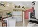Open kitchen with bright white cabinets, stainless steel appliances, and breakfast bar at 8113 Sun Palm Dr, Kissimmee, FL 34747