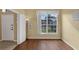 Cozy living room featuring wood floors, large window and a doorway at 8113 Sun Palm Dr, Kissimmee, FL 34747