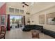The Living Room features a ceiling fan, a sitting area, and sliding door access to the screened pool area at 8113 Sun Palm Dr, Kissimmee, FL 34747