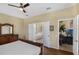 The main bedroom offers a ceiling fan, wood flooring, and an ensuite bathroom with a soaking tub at 8113 Sun Palm Dr, Kissimmee, FL 34747