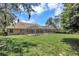 This is a generous backyard with an enclosed pool area and lush greenery on a sunny day at 8623 Summerville Pl, Orlando, FL 32819