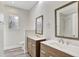Bathroom featuring double sinks with modern vanities and a walk-in shower at 8623 Summerville Pl, Orlando, FL 32819