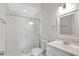 Bright bathroom featuring a glass shower, white toilet, and a sleek vanity with a framed mirror at 8623 Summerville Pl, Orlando, FL 32819
