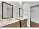 Bright bathroom featuring double sinks, white countertops, and modern wood grain cabinetry at 8623 Summerville Pl, Orlando, FL 32819