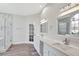 Beautiful bathroom featuring dual vanities with quartz counters, sleek mirrors, and a glass-enclosed shower at 8623 Summerville Pl, Orlando, FL 32819