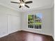 Cozy bedroom featuring hardwood floors, a ceiling fan, and a closet at 8623 Summerville Pl, Orlando, FL 32819