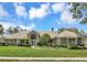 Beautiful home with a manicured lawn, arched entryway, and meticulously maintained landscaping at 8623 Summerville Pl, Orlando, FL 32819